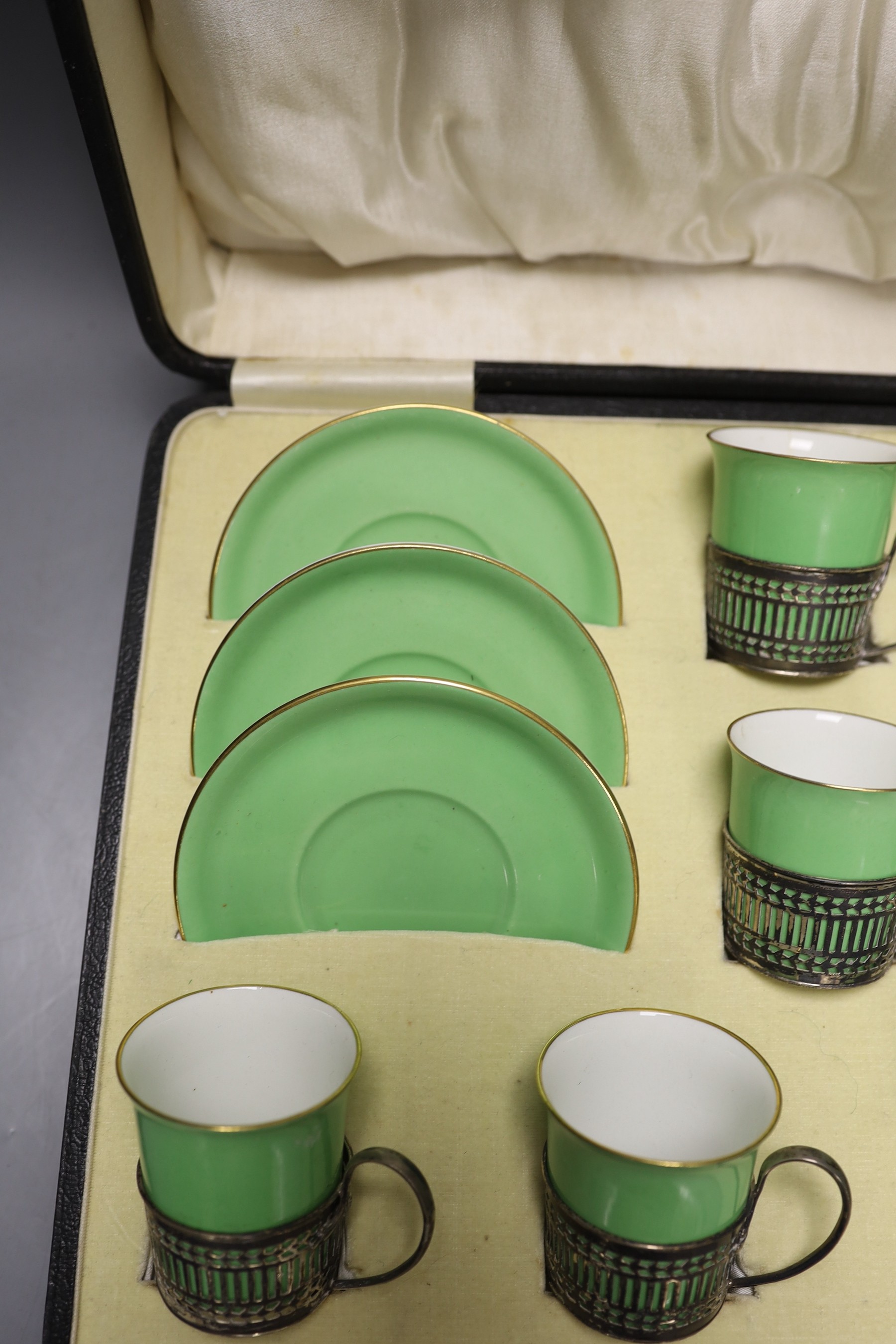 Boxed set of six Shelley 8775/4 green coffee cans and saucers in silver handle mounts